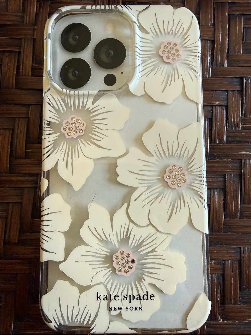 Kate Spade 14 Pro clear with white & pink flowers. Used.